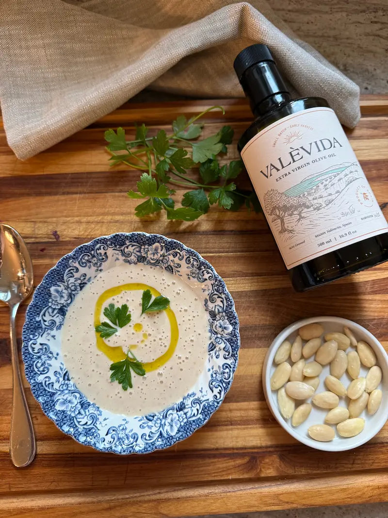 Chilled ajoblanco in a bowl with fresh parsley and a swirl of Valèvida extra virgin olive oil