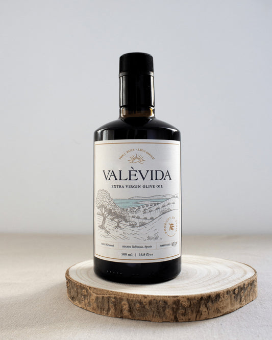 A single bottle of Valèvida extra virgin olive oil showing the front label and hand-written harvest date