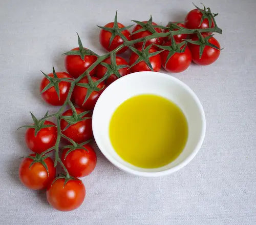 Valèvida extra virgin olive oil being poured into a small tasting glass